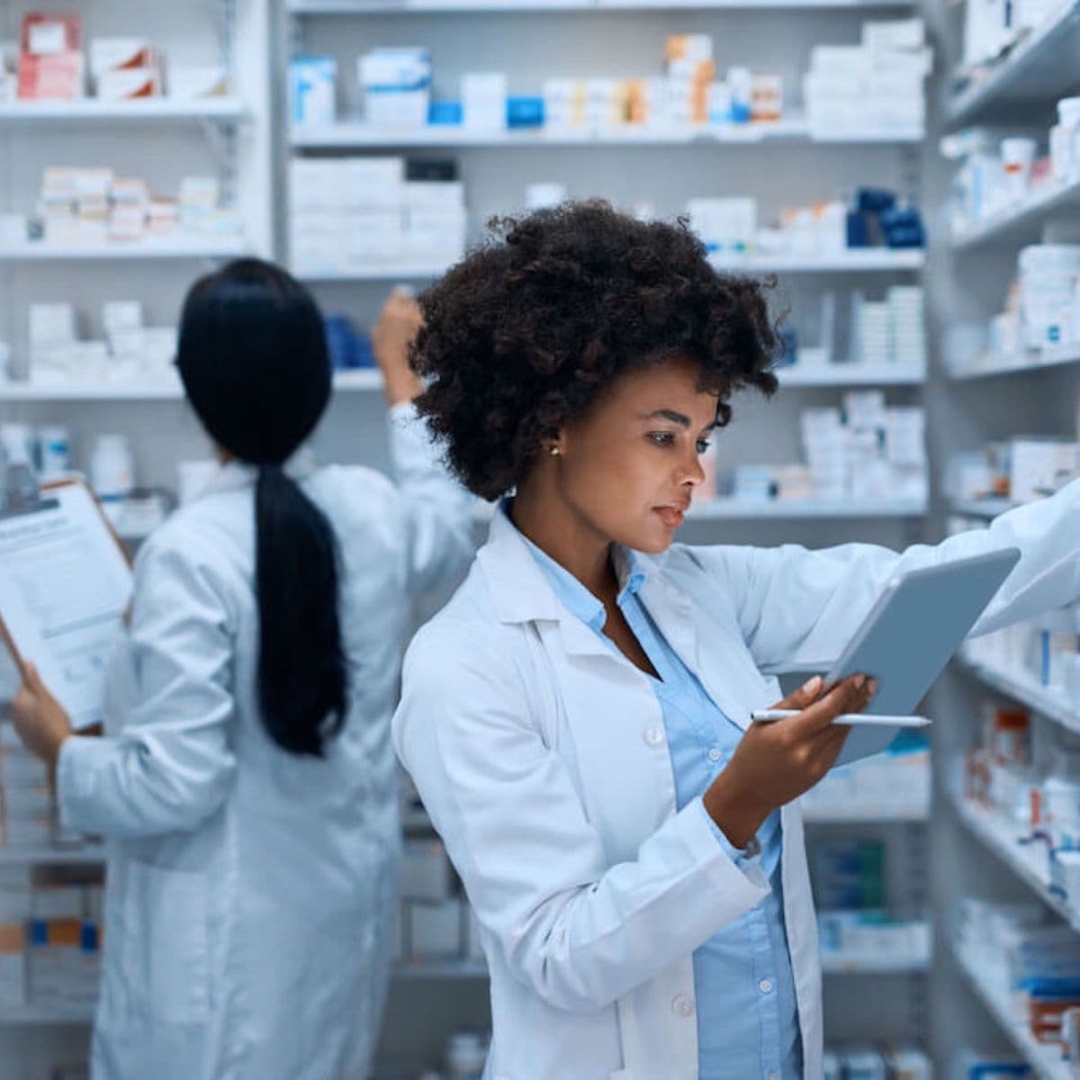 Pharmacists checking stock on a tablet
